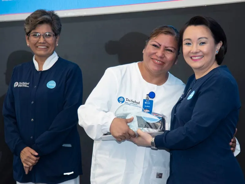 Sayuri Komera, directora de Enfermer&iacute;a de TecSalud, entregando un reconocimiento durante el simposio.
