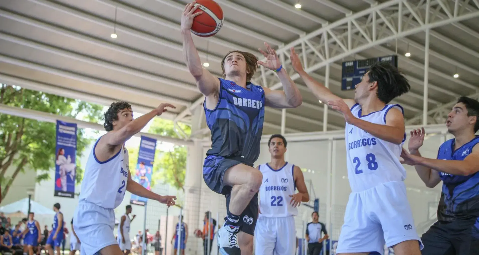 Cinco estudiantes jugando básquetbol, luchando por tener el balón en Intercampus Guadalajara.
