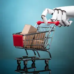 Robot sosteniendo un carrito de compras con cajas de cartón sobre fondo turquesa